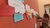 Woman putting post its on wall, brainstorming session